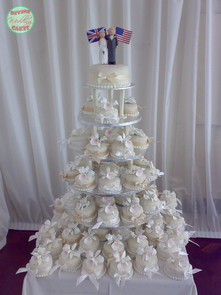 a tower of individual wedding cakes with sugar orchids on